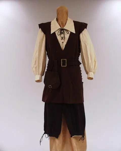 Costume Kirsten Flagstad in the role of Fidelio in Fidelio by Beethoven. A white blouse with a brown leather waistcoat and matching belt around the waist. Brown leather knickerbockers.