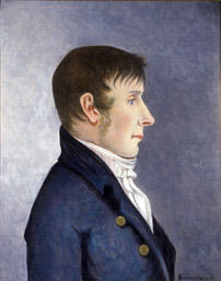 Portrett av Jørgen Aall.  Mann i profil, mørkt, kort hår, kinnskjegg  Mørk blå kledning med to knapper, hvit skjorte