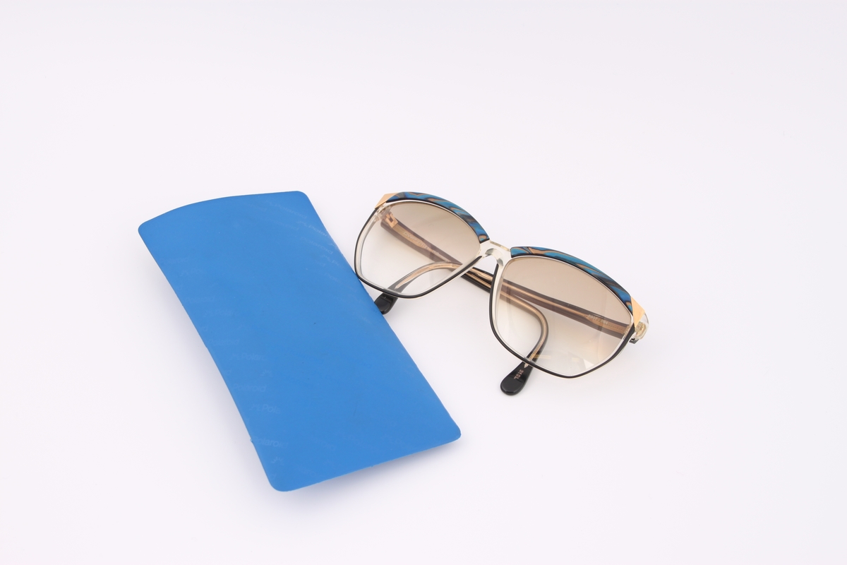 Solbriller i blått plastetui merket "Polaroid".