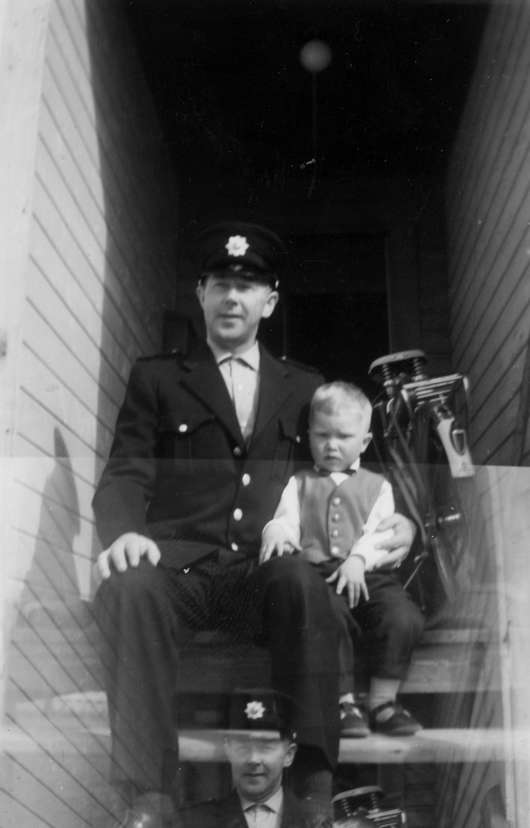 Mathis Henriksen i brannmannsunfirom med sønnen Per Johan ved sin side. Vadsø, ca. 1965.