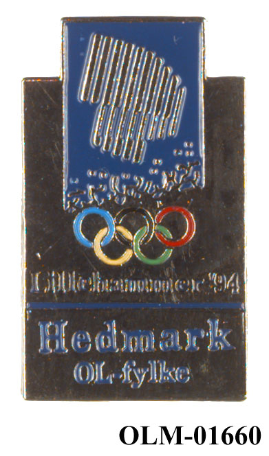 Merke med emblemet for Lillehammer '94 og Hedmark fylkesvåpen.