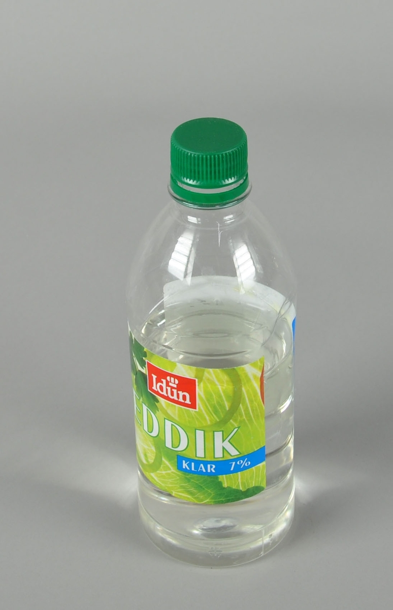 Gjennomsiktig flaske med grønn kork.