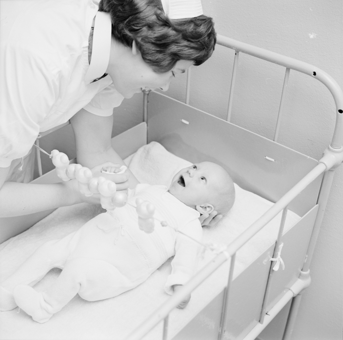 Barnsköterskan Lena Jansson tillsammans med ett spädbarn på Gillbergska barnhemmet, Sysslomansgatan 37