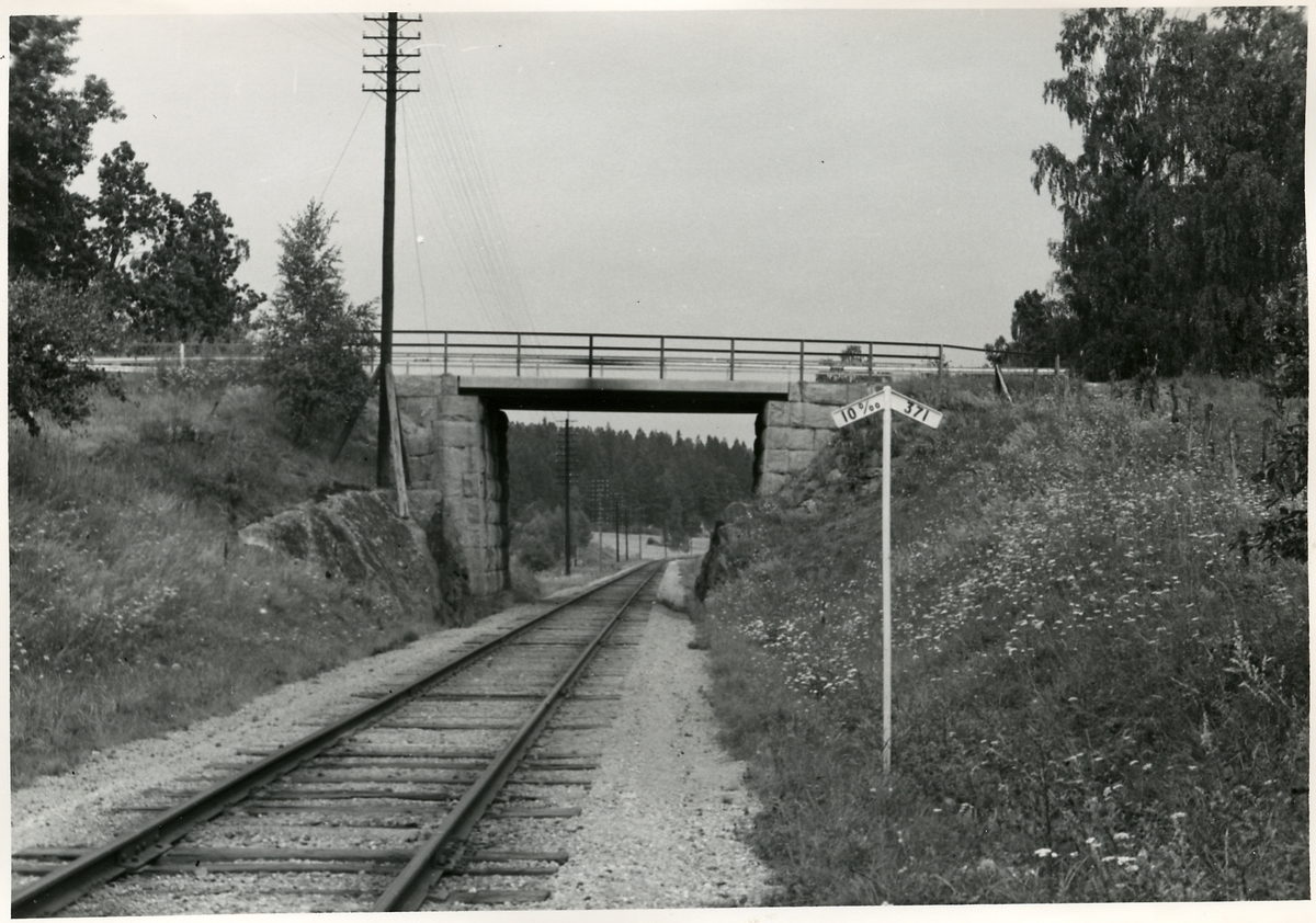 På linjen mellan Flen - Silinge, vägbro, mot norr. Bilden tagen inför elektrifieringen av Trafikaktiebolaget Grängesberg - Oxelösunds Järnvägar.