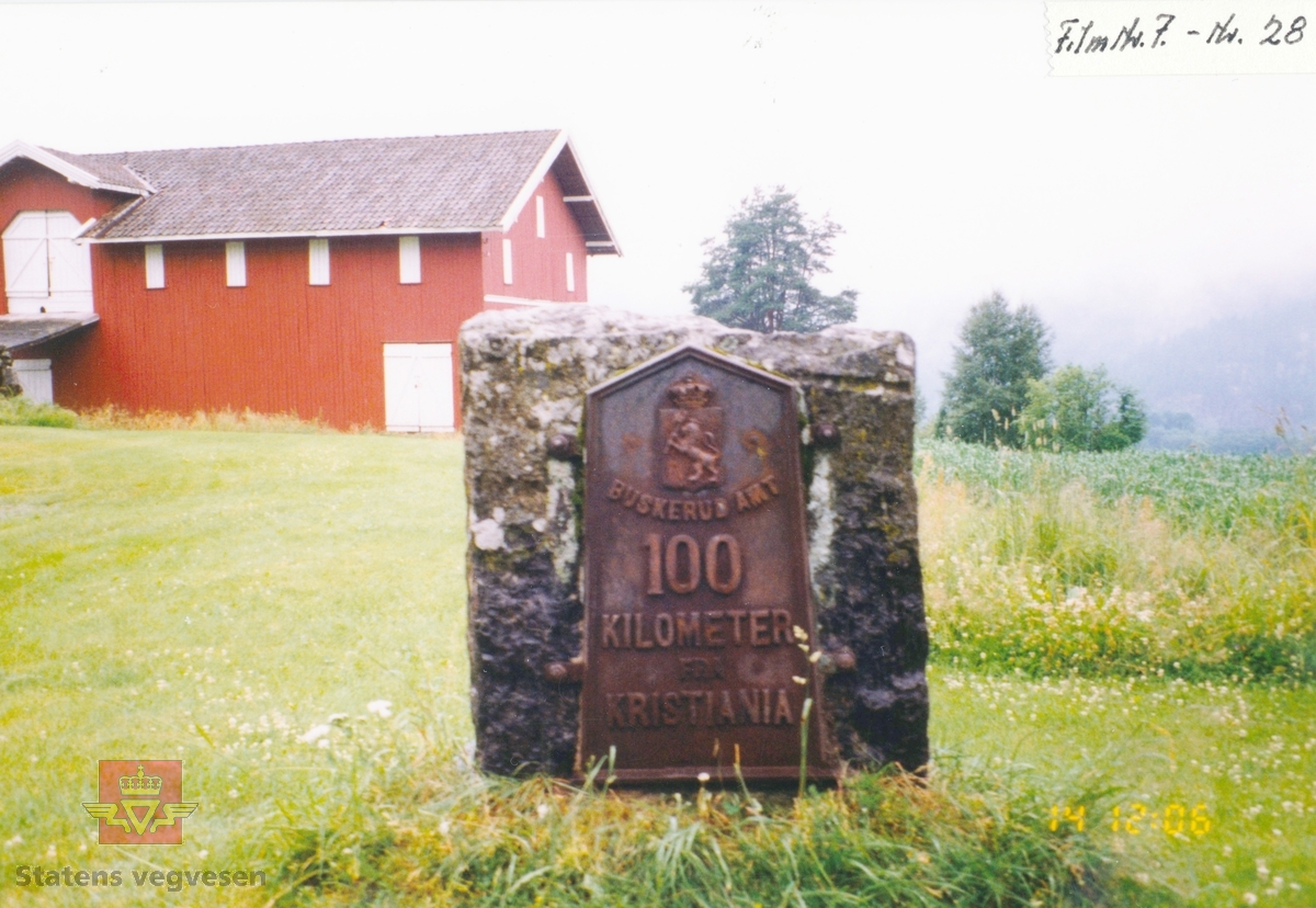 Støpejern milepæl montert på stein på Lofthusvegen ved Snarum kirke. Tekst: Buskerud Amt 100 km fra Kristiania