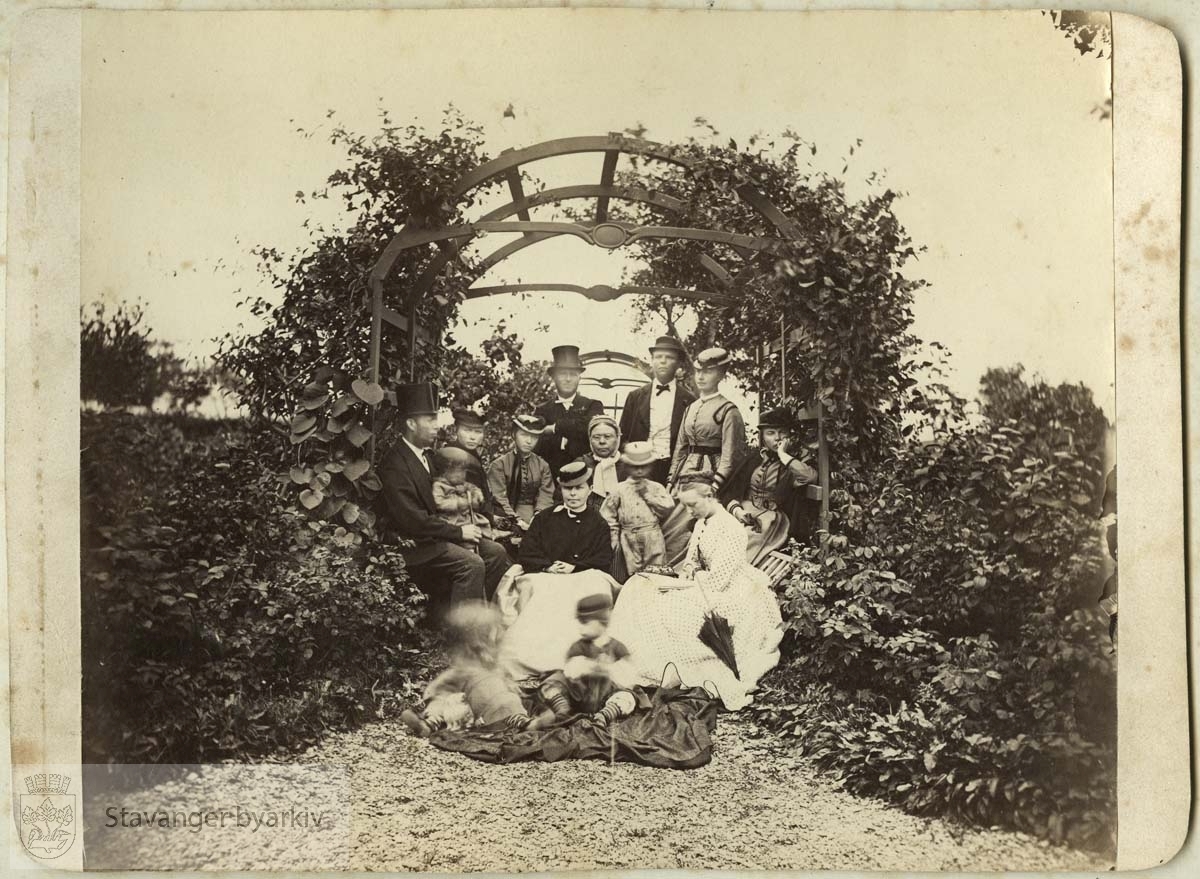 Til venstre kjøpmann Erik S. Monsen (1838-1885) med sønnen Jonas Schanche f. 1867. Stående til høyre bak: Skipsreder Mons Gabriel Monsen (1836-1896) og Bergithe Monsen, f. Tausan (1841-1910)