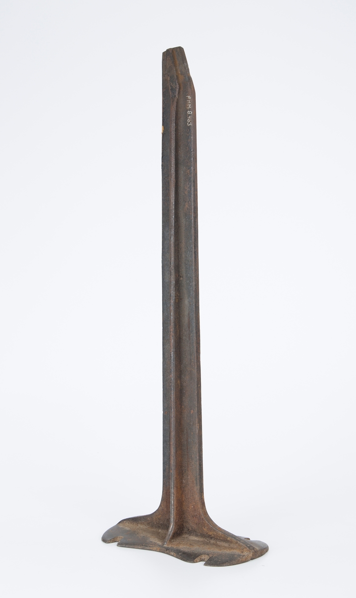 Jern stativ med skoform på toppen (FHM.0874). Opplysninger kan faaes hos skomaker O. Pedersen i Droebak