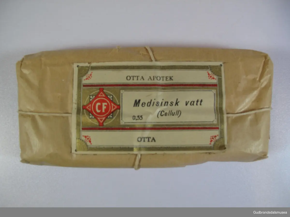 7 pakker medisinsk vatt (cellull) à 25 gram fra Otta Apotek. Innpakket i brunt grovpapir med hyssing.