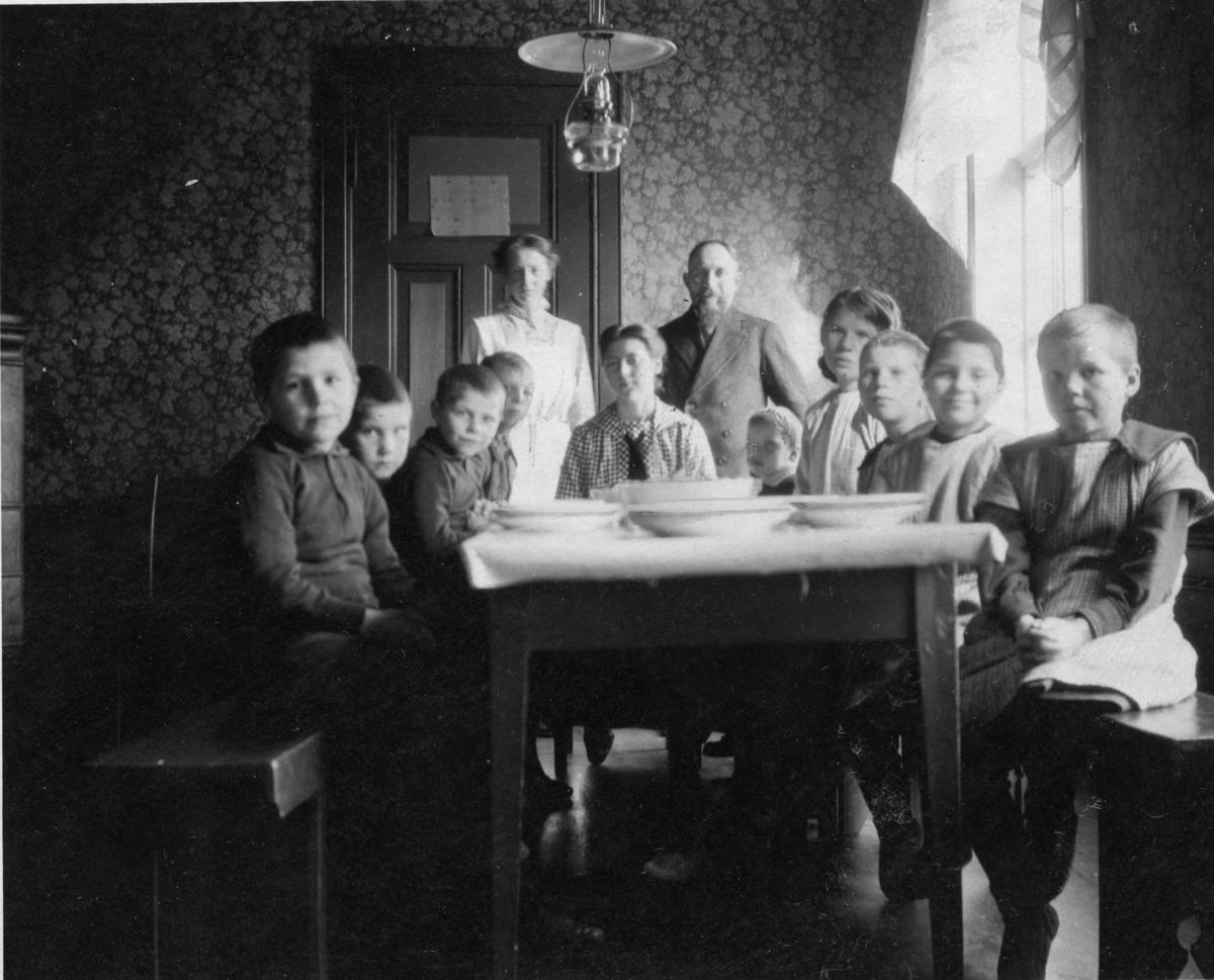 Children and adults around the dining table, orphanage at Haugen, 1918.