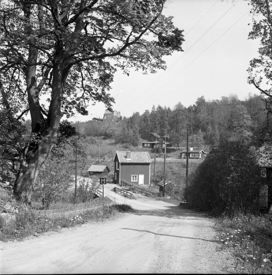 Bron i Röttle från söder (från Västanå) med så kallade affären i blickpunkten och Gyllene Uttern på höjden i bakgrunden.