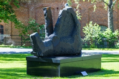 Skulpturen forestiller en hest, kanskje en fole, som ligger med bena i været.