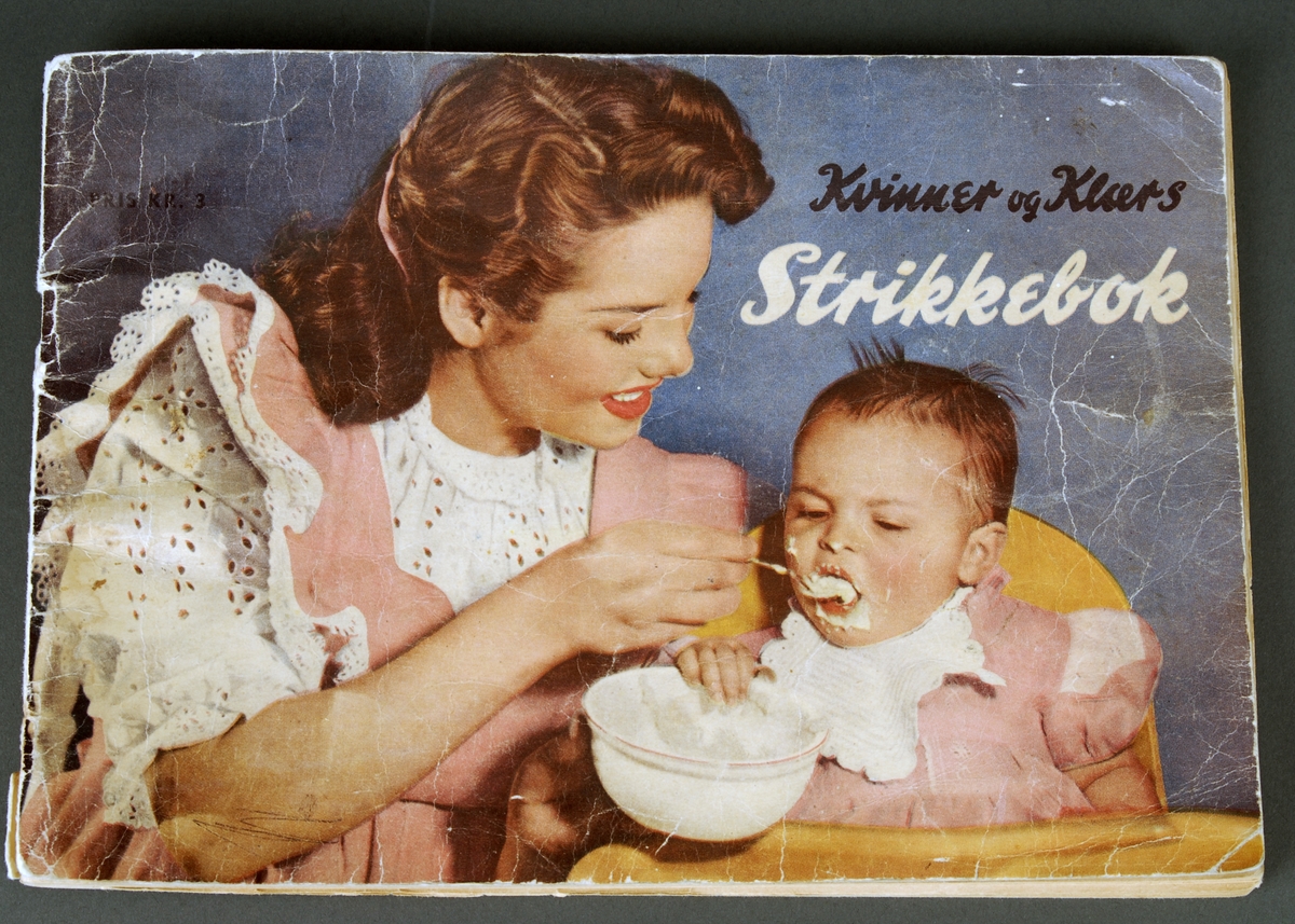 På framsiden:Dame som mater et barn.
På baksiden: Garnkruv med strikkepinner og en hund. Målbånd