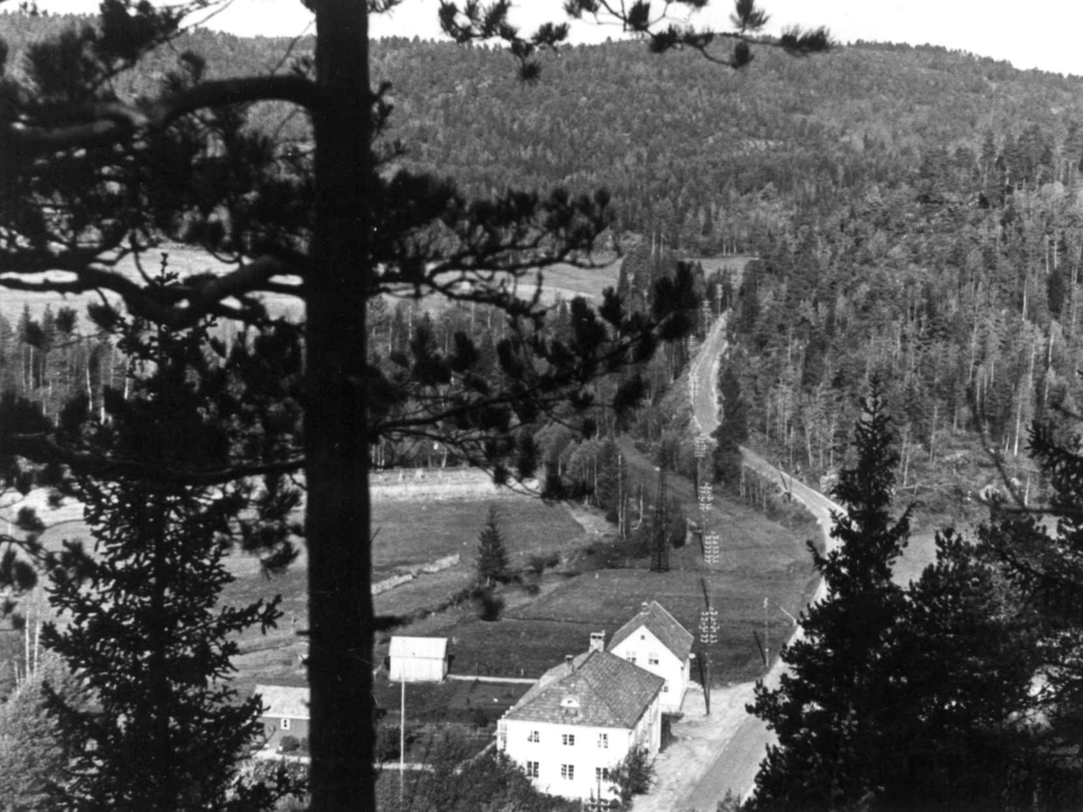 Oversiktsbilde fra Fiane med bygninger ved en vei, 1938.