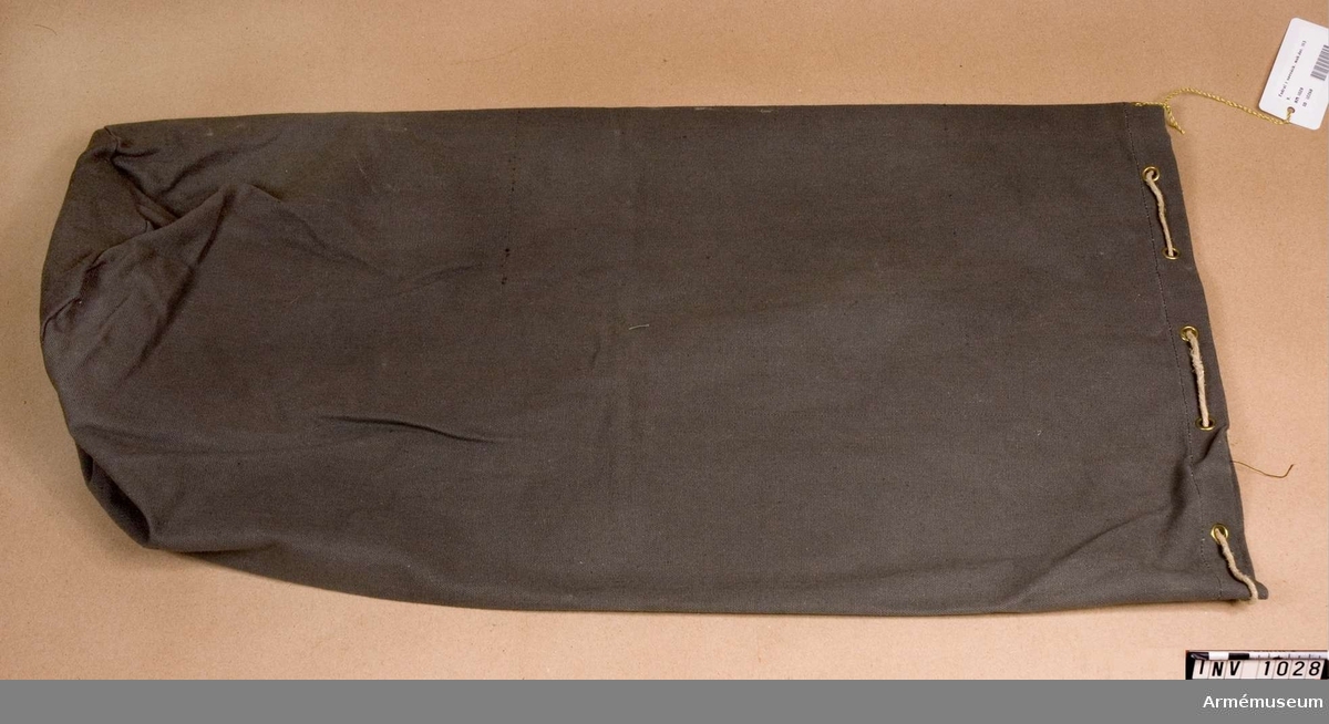 Samhörande nr är 1017-1059, 1062-1063, 1072-1073.Fodral t sovsäck 1939.Av gråbrungrön smärting. Sydd med en enkel söm med rund botten. Används som fodral till den hoprullade sovsäcken eller andra persedlar. Har tillhört mobiliseringsutrustning vid museet.