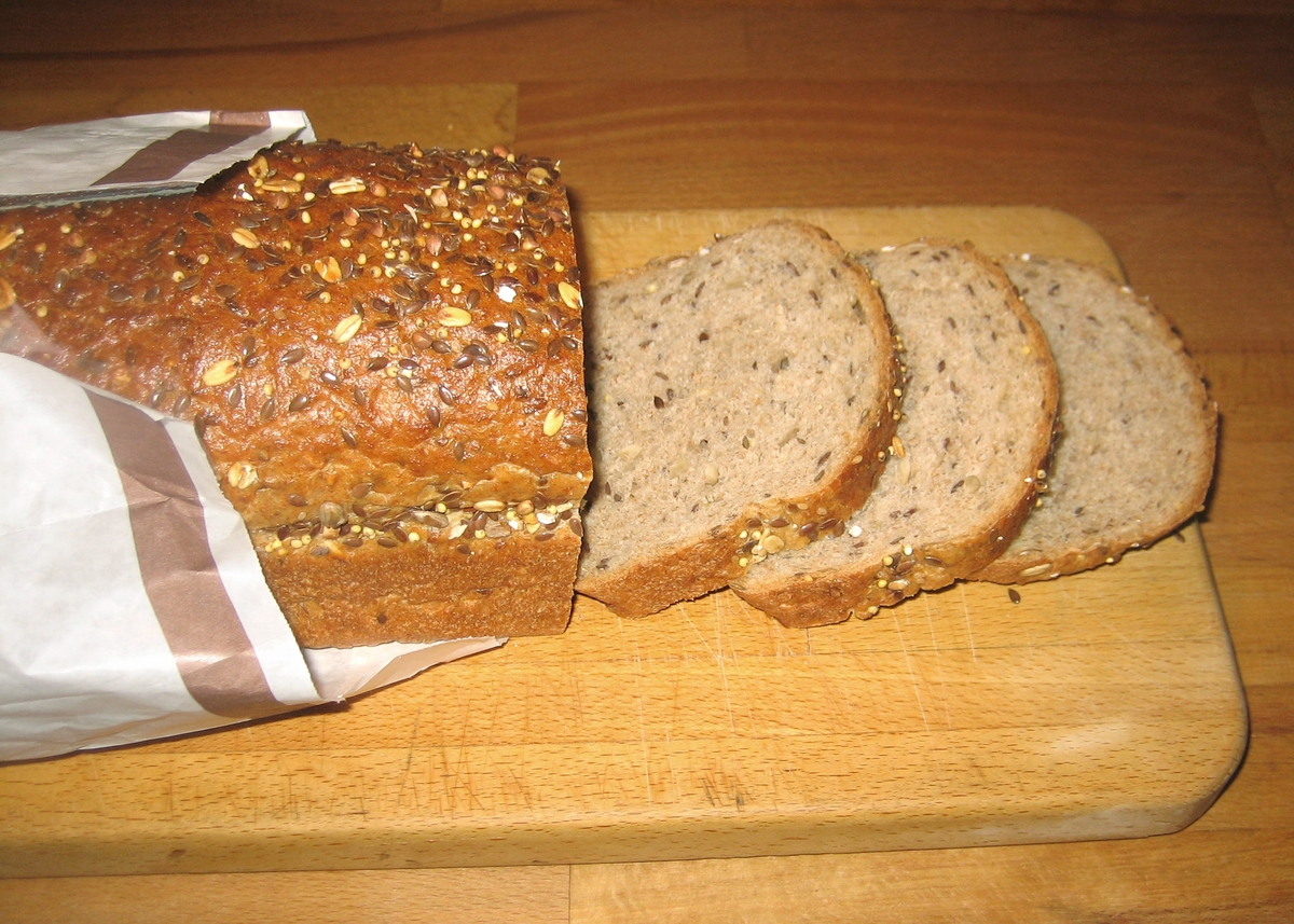 Forsiden: En tegning av en baker i bakerklær holder et nystekt varmt brød. Nøkkelhull ikon på forsiden.