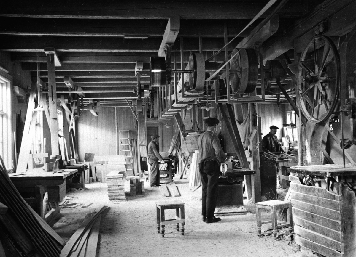 Interiør, snekkerverksted, O. Johansens trevarefabrikk, Moelv. Foran er Dalseth, til høyre er Simensen. Sag og pussemaskiner med removerføring.